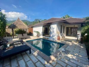 a swimming pool in the backyard of a house at Bamboo Villa in Ko Tao