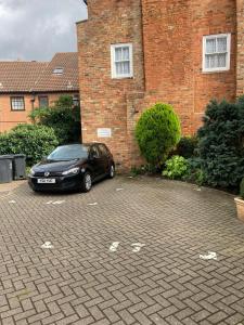 um carro preto estacionado em frente a um edifício de tijolos em Rooftops em Louth