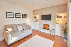 a living room with a couch and a fireplace at Host & Stay - Newsam Crescent in Eaglescliffe