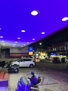 a parking lot with cars and motorcycles in a parking garage at MADAPARAMBIL RESIDENCY in Alwaye
