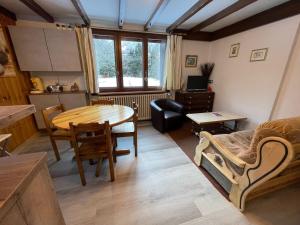 a living room with a table and a dining room at Apartment Maison Novel by Interhome in Chamonix-Mont-Blanc