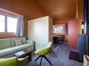 a living room with a couch and a chair at Holiday Home Maiensäss Komfort by Interhome in Urmein