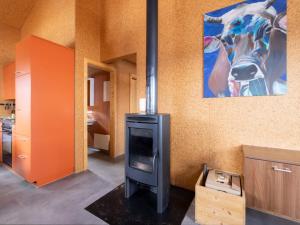 a kitchen with a stove and a painting on the wall at Holiday Home Maiensäss Komfort by Interhome in Urmein +47 photos