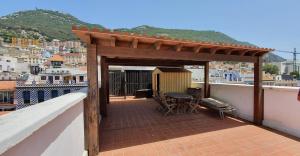 a wooden pergola on a balcony with a view of a city at Gibraltar Town Centre Flat with Roof Terrace in Gibraltar