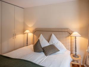 a bedroom with a bed with two pillows on it at Apartment Chesa Crusch 7 by Interhome in Samedan