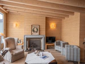 a living room with a fireplace and wooden walls at Apartment Chesa Crusch 7 by Interhome in Samedan