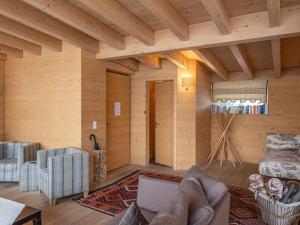 a living room with a couch and a chair at Apartment Chesa Crusch 7 by Interhome in Samedan