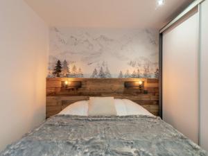 a bedroom with a bed with a wooden wall at Apartment Le Curling A-18 in Tignes