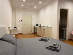 a bedroom with a bed with two towels on it at Les trois merveilles in Cesena