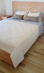 1 cama grande con sábanas y almohadas blancas en Apartamento con vistas, en Montevideo