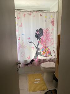 a bathroom with a shower curtain with a fairy at Hermoso departamento nuevo en Pucon equipado con 3 dormitorios wifi y estacionamiento privado a 5 minutos del centro y lago in Pucón