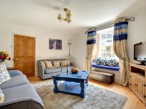 a living room with a couch and a table at Holiday Home Cross Keys by Interhome in Padstow