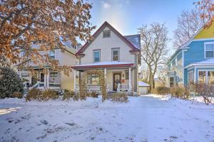 a group of houses with snow on the ground at Charming Saint Paul Home with Yard, Near Downtown! in Saint Paul