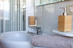 a bathroom with a sink and a bath tub at CASA PARADISO - Vista valle in Cavalese