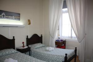 En eller flere senger på et rom på Pensao Residencial Estrela do Mondego