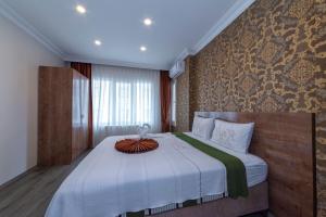 a bedroom with a large bed with a white blanket at Sufra Suite in Istanbul