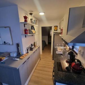 a kitchen with a counter and a counter top at EXCLUSIVO PENTHOUSE EN CORDON SOHO con parrillero in Montevideo +16 photos