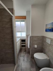 a small bathroom with a toilet and a window at [WHITE & WOOD house in Rome] in Rome