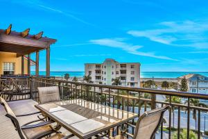 a balcony with a table and chairs and the ocean at Palms of Treasure Island 405 in St. Pete Beach