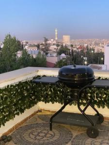 a bbq grill sitting on top of a balcony at The view II in Amman