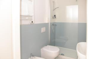 a bathroom with a shower and a toilet and a sink at La Rosa rooms & holiday home in Porto SantʼElpidio +32 photos