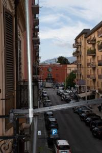 a city street with cars parked in a parking lot at Maison L'amuri in Palermo