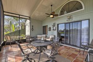 a dining room with a table and chairs on a patio at Lakefront Brandon Home with Patio and Screened Lanai! in Brandon