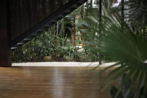 a wooden floor in a room with plants at Outsite Santa Teresa Playa in Santa Teresa Beach