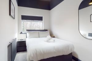 a bedroom with a white bed and a window at Air Host and Stay - Wright Terrace, 4 bedroom, 2 bathroom sleeps 8 in Liverpool