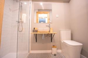 a bathroom with a shower with a toilet and a sink at ALYA junto a CARD in Sierra Nevada