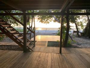 a wooden porch with a view of the beach at FlowMove Retreat Algodoal in Algodoal