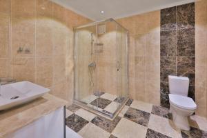 a bathroom with a shower and a toilet and a sink at Villa Çalıkuşu Kalkan in Kaş +10 photos