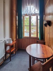 a dining room with a table and a window at Willa Słoneczko in Szklarska Poręba