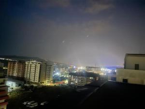 a view of a city at night with lights at Apartament Cluj in Floreşti