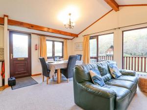 a living room with a couch and a table at Dartmoor Retreat Lodge in Exeter