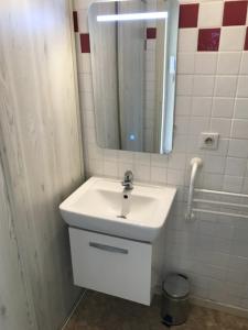 a bathroom with a white sink and a mirror at Charming Studio With Terrace And 180 Sea View in Six-Fours-les-Plages