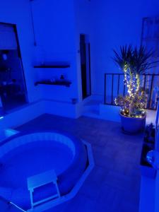 a blue room with a tub and a plant at First house in Brindisi