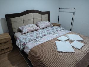 a bed with two sheets and two napkins on it at Apartman Jakša in Žabljak