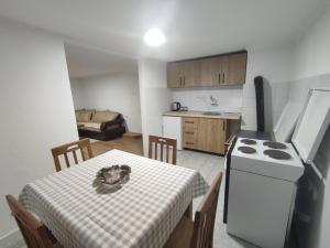 a kitchen and dining room with a table and a stove at Apartman Jakša in Žabljak
