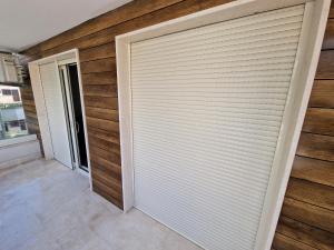 a garage door with a roller blind on it at AS Apartments Rafailovici in Rafailovici