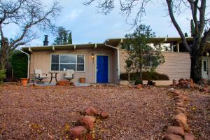 a house with a blue door and a yard at The Three Keys duplex in Sedona