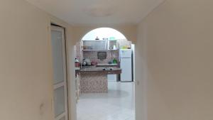 a kitchen with an arched window and a white refrigerator at Studio Au Centre Ville Prés de la Medina in Fez