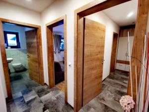 a bathroom with two open doors and a toilet at Haus Dirol in Kirchberg in Tirol