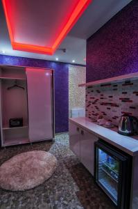 a kitchen with purple and purple walls and a counter at Ag Şişli Hotel in Istanbul