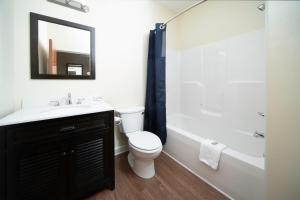 a bathroom with a sink and a toilet and a tub at Mt. Rose Hotel in Fayetteville