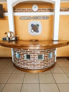 a wooden table with a clock on top of a building at VILLAS MARCO POLO in Panajachel