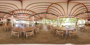 a large room with tables and chairs in it at NIVADOO RESORT SIGIRIYA in Sigiriya