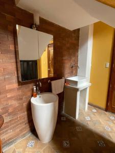 a bathroom with a tub and a sink and a mirror at VILLAS MARCO POLO in Panajachel