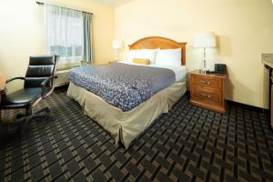 a hotel room with a bed and a desk and a chair at Mt. Rose Hotel in Fayetteville