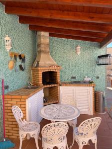 a patio with a table and chairs and an oven at Villa Casa Velha in Portimão